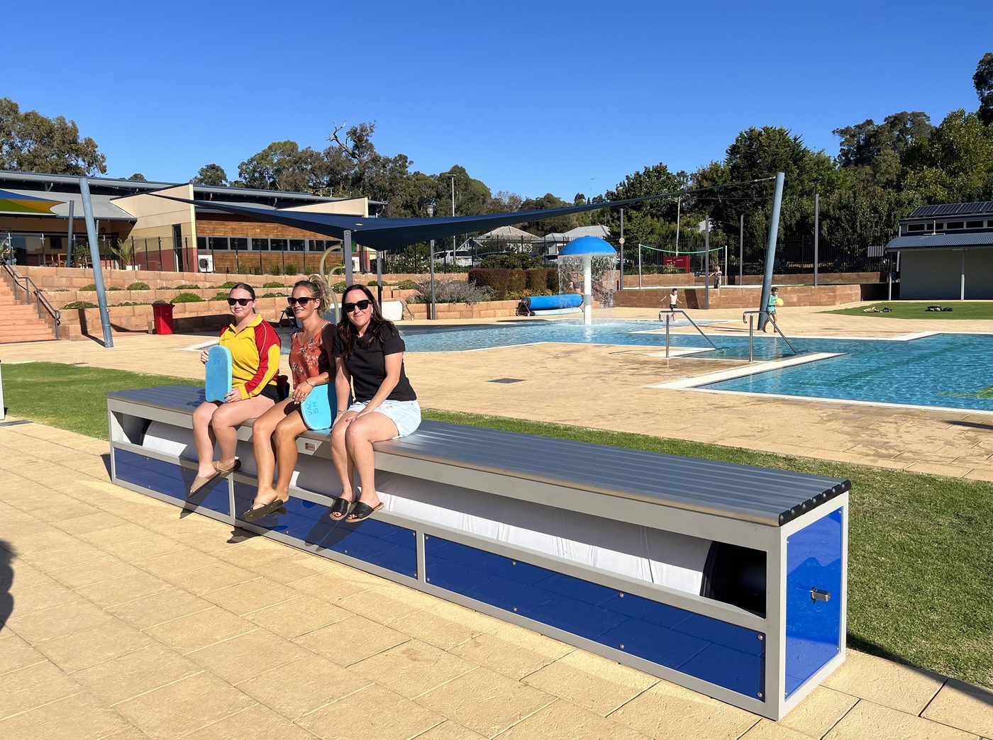 Elite blanket storage bench seat beside a commercial pool