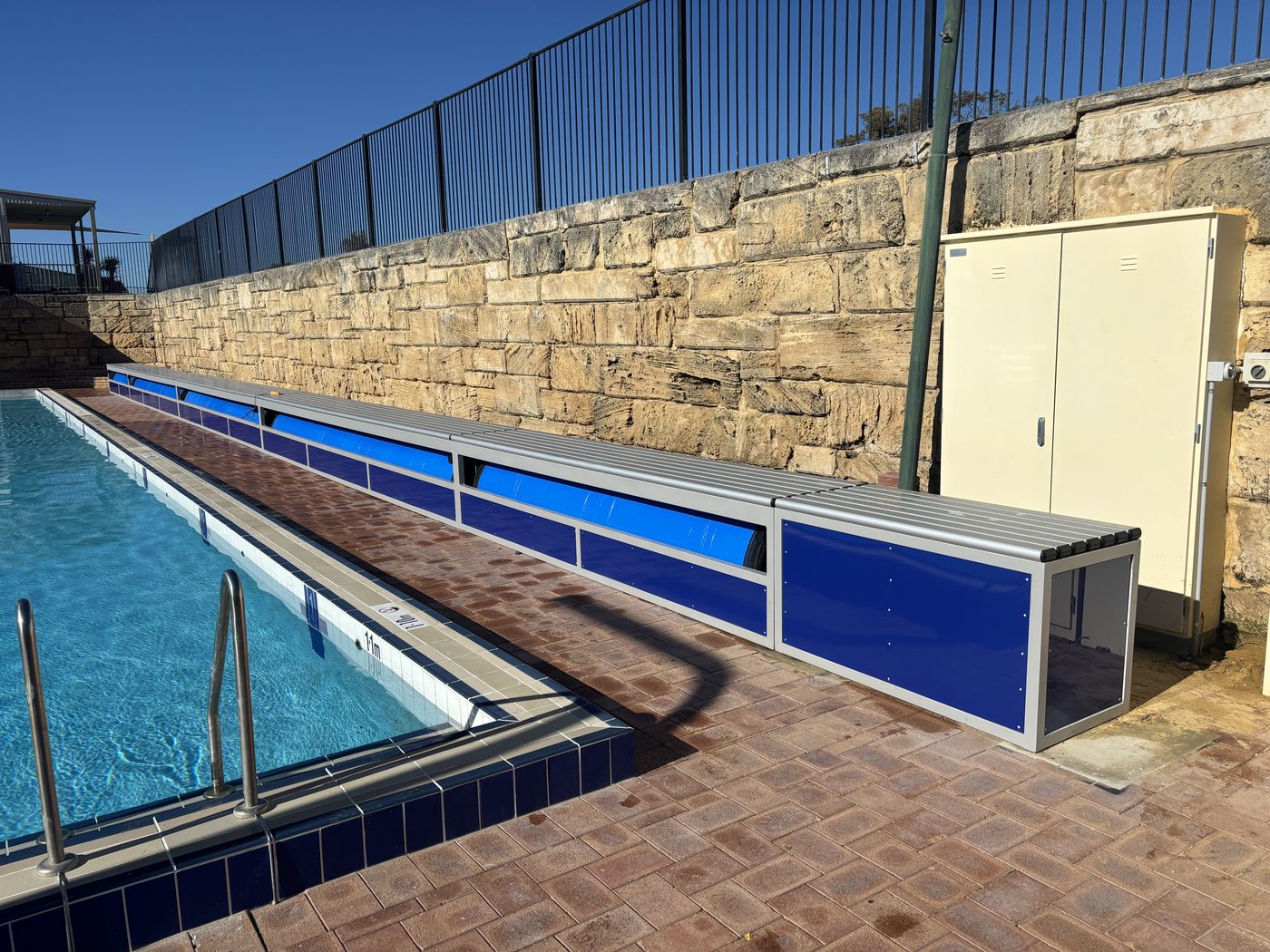Elite commercial roller systems installed along a commercial pool deck