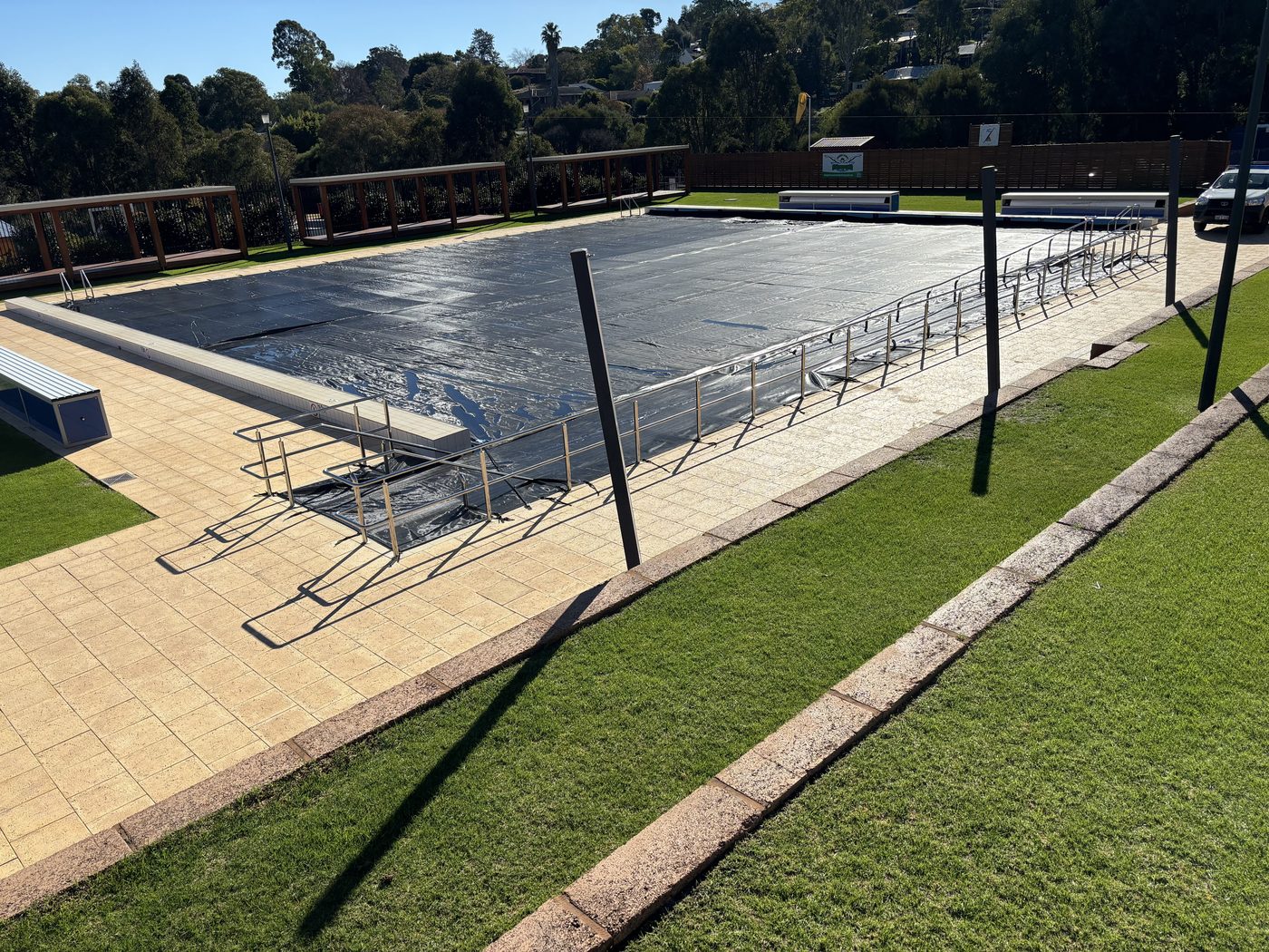 Elite winter and security cover, partly rolled back on a commercial pool